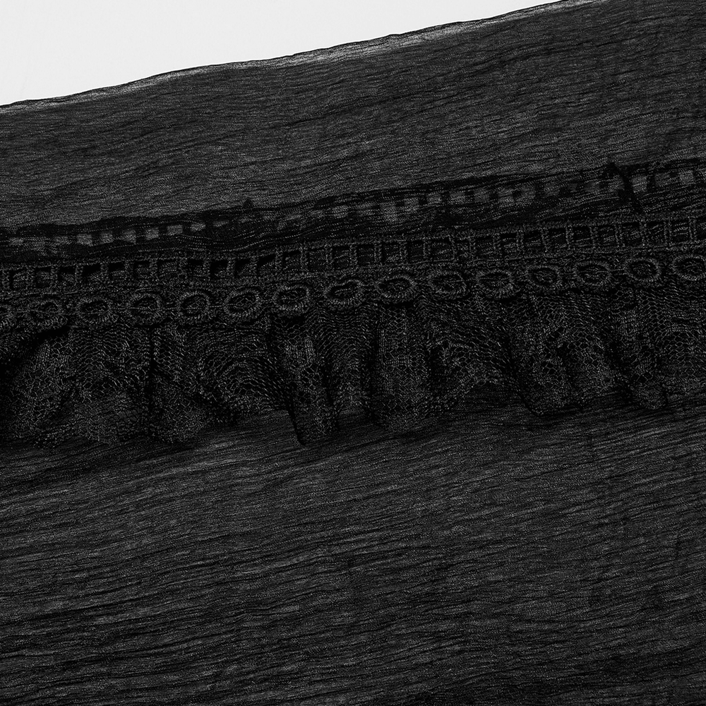 Close-up of delicate wave lace detailing on elegant black chiffon fabric for gothic clothing.