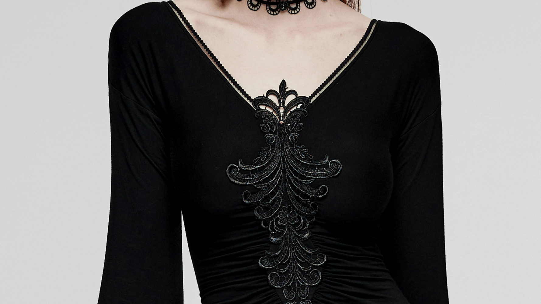 Elegant black gothic dress with flared sleeves and intricate lace detailing on the neckline.