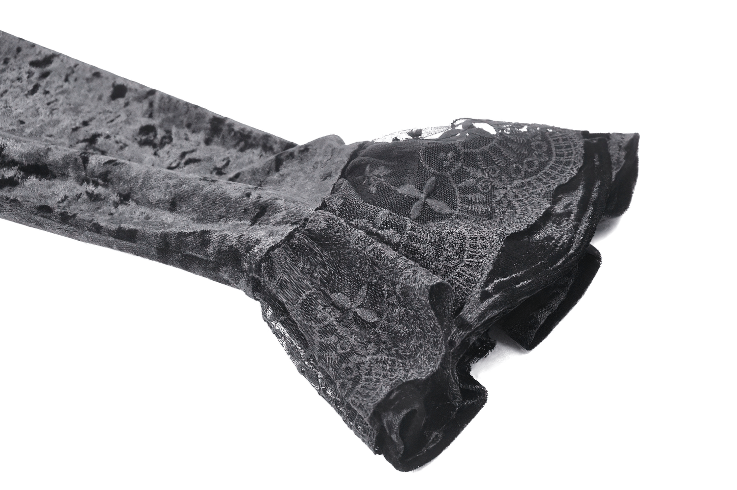 Close-up of elegant lace bell sleeves on a black velvet dress, showcasing gothic style and dramatic flair.