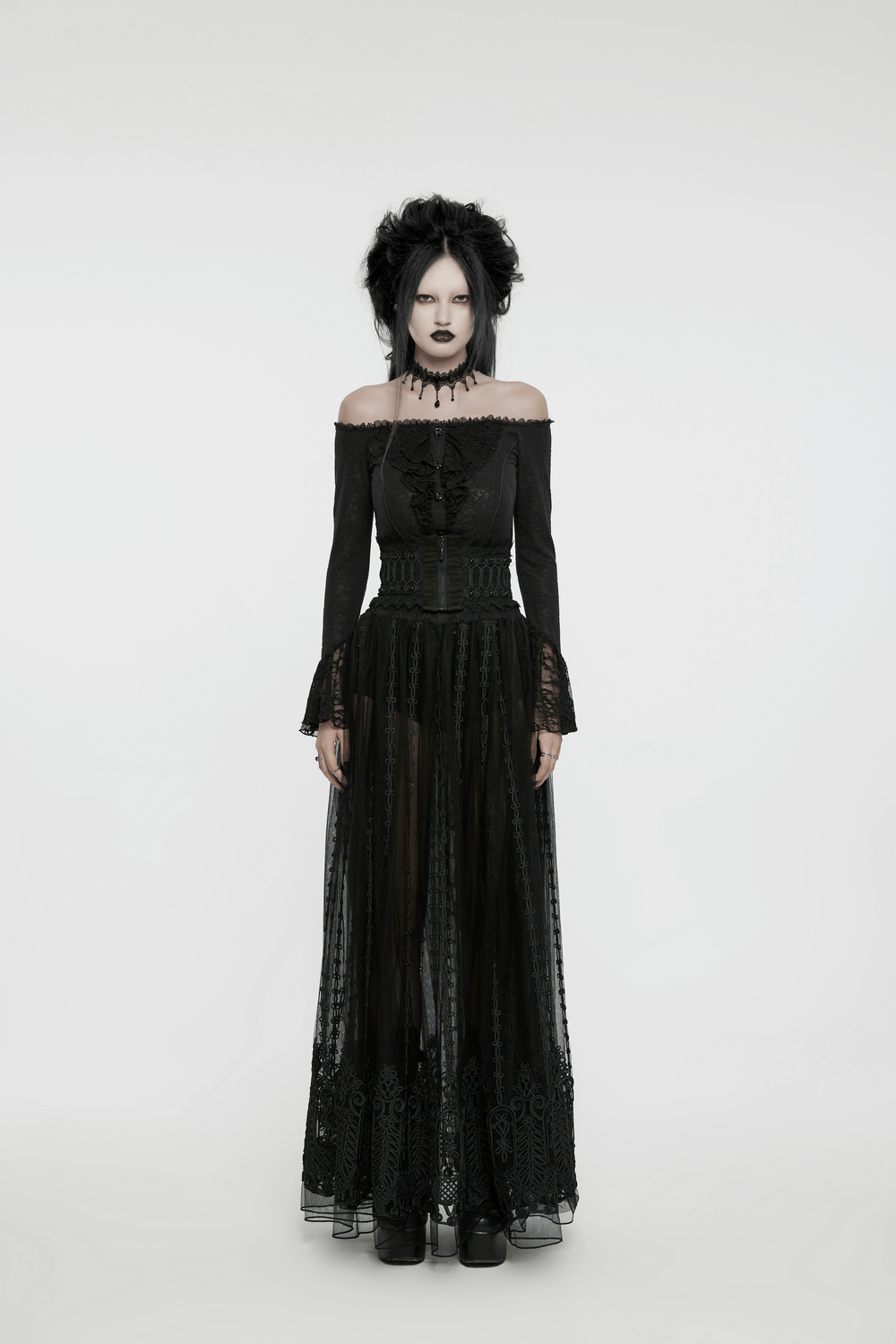 Elegant goth model in black off-shoulder dress with lace detailing, showcasing a mysterious and ethereal style.