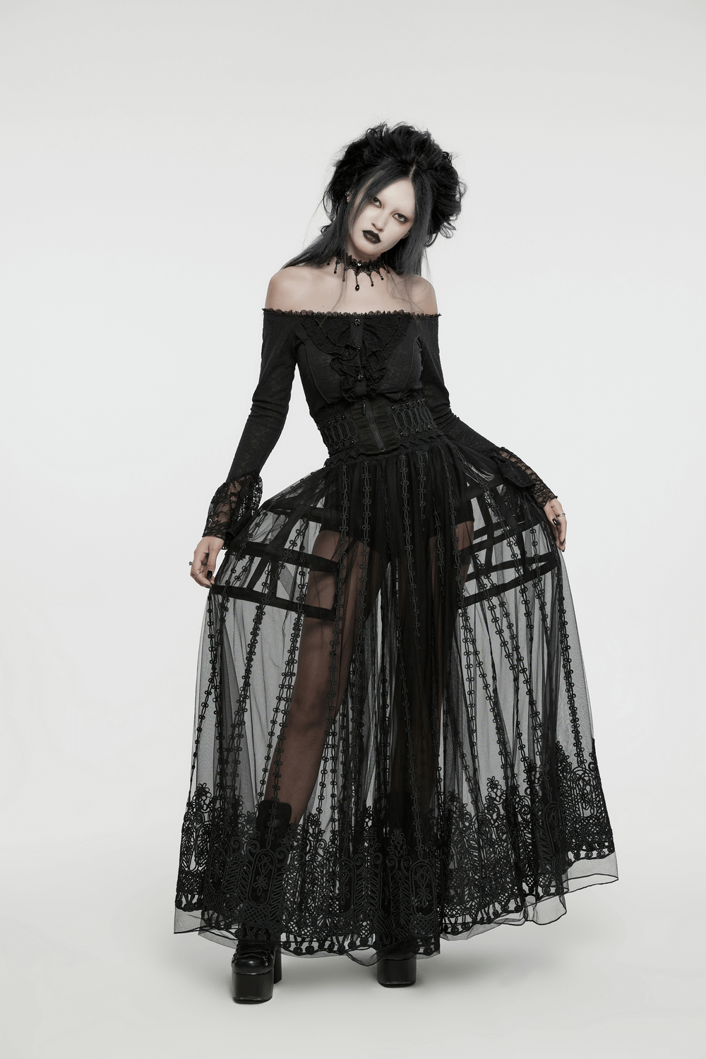 Elegant goth model in sheer black maxi skirt with intricate lace and floral details, exuding mystery and ethereal beauty.