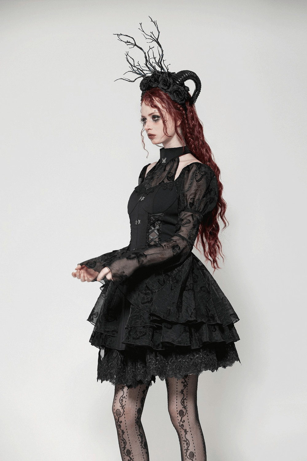 Elegant Gothic mini dress with butterfly accents and lace details, styled with a dramatic black hat and accessories.