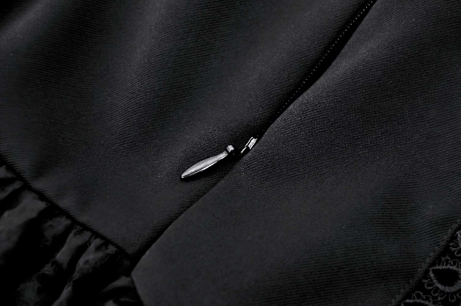 Close-up of the zipper detail on an Elegant Gothic Mini Dress with butterfly accents and stylish lace.