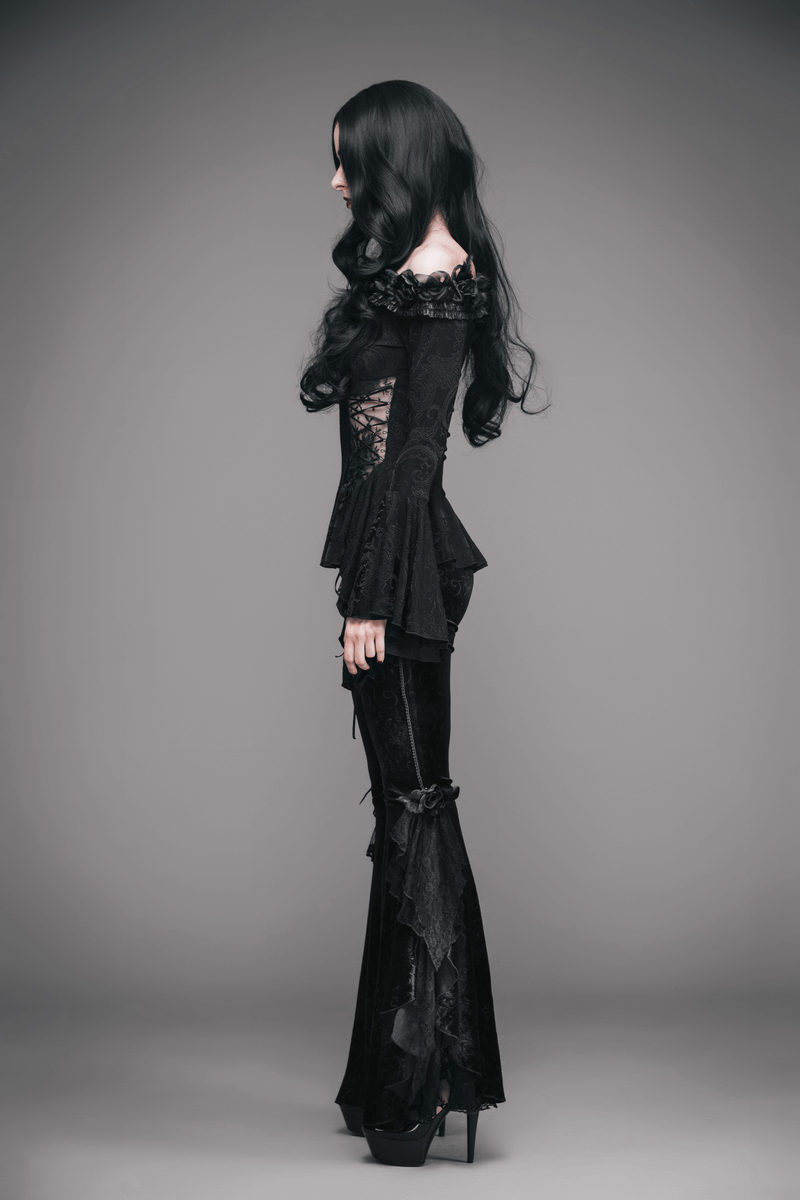 Elegant black gothic top with flared sleeves, lace-up details, and feather accents worn by a model.