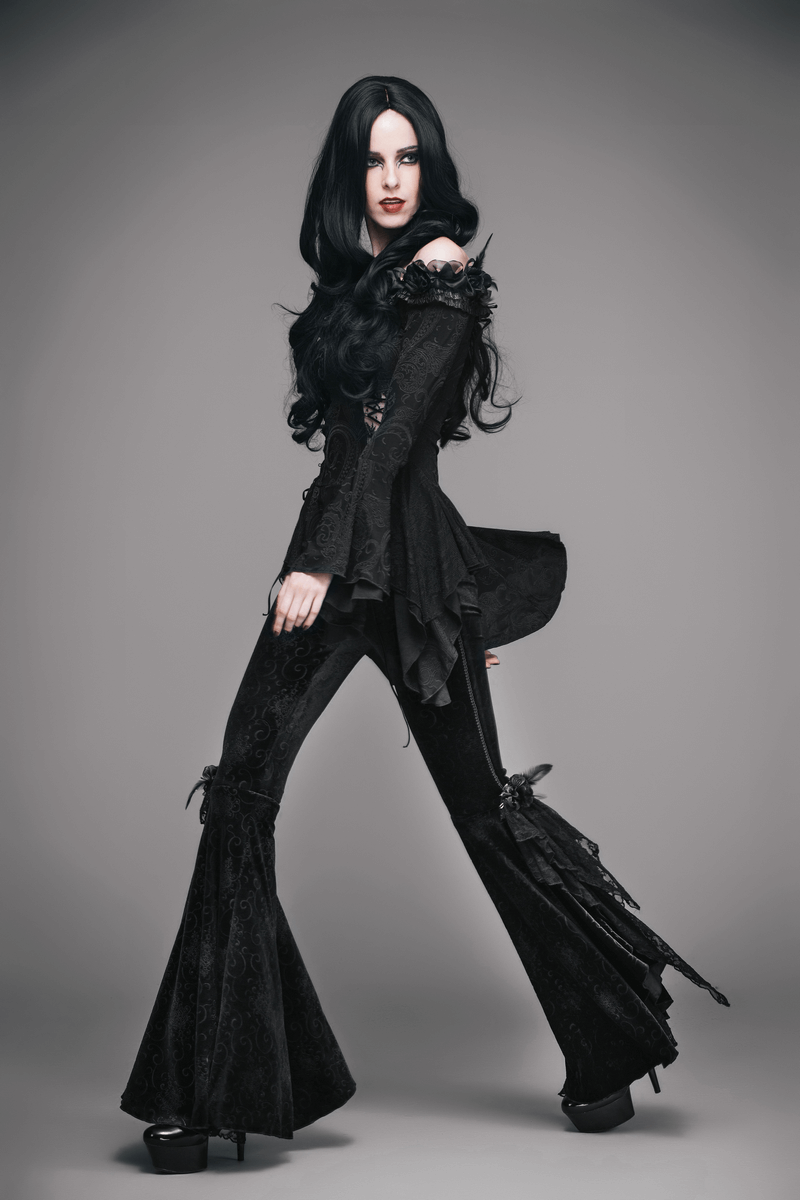 Gothic women's top with lace-up and flared sleeves, paired with stylish black pants, showcasing a trendy dark fashion look.