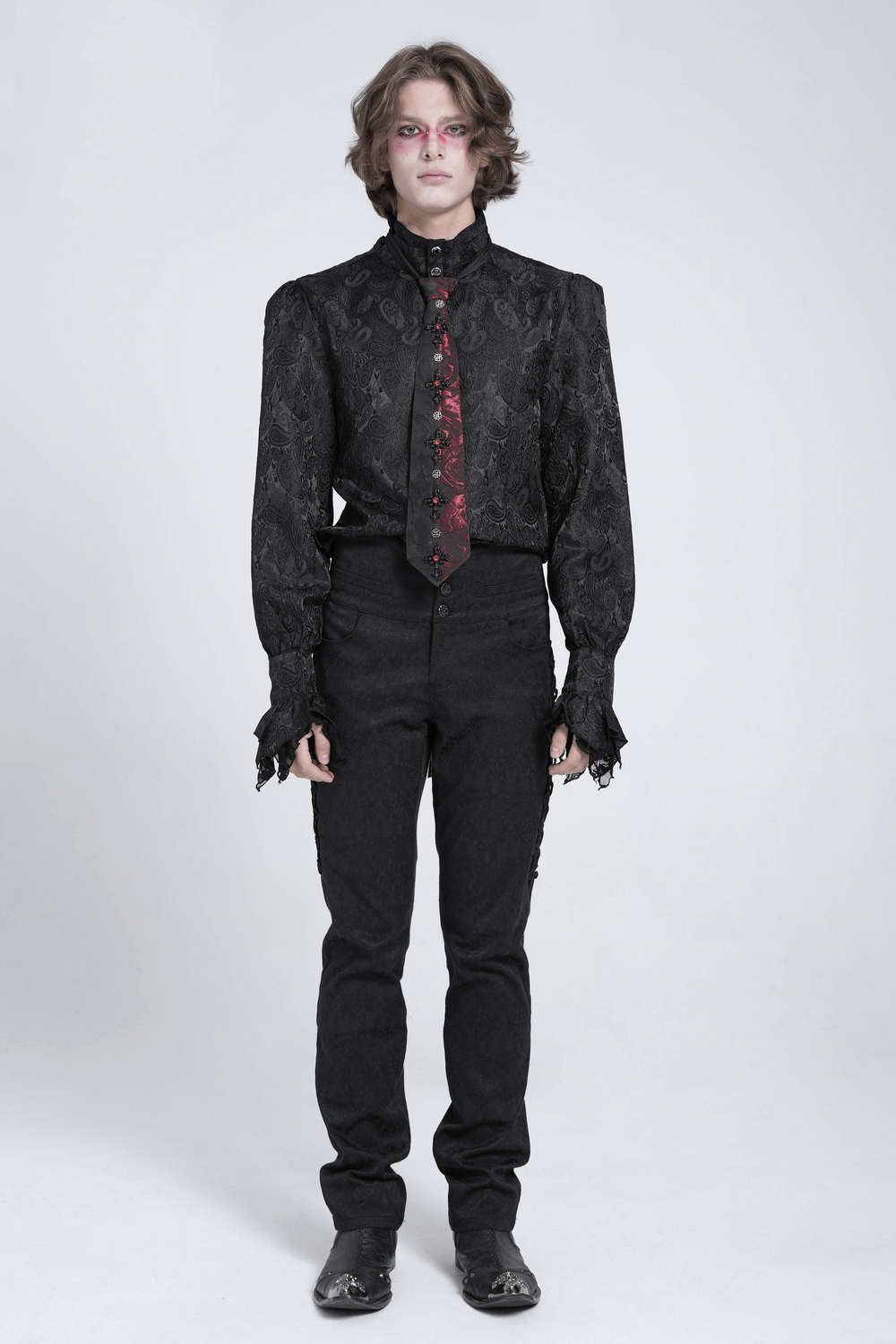 Gothic model wearing an elegant red and black floral crystal necktie with a stylish black outfit.