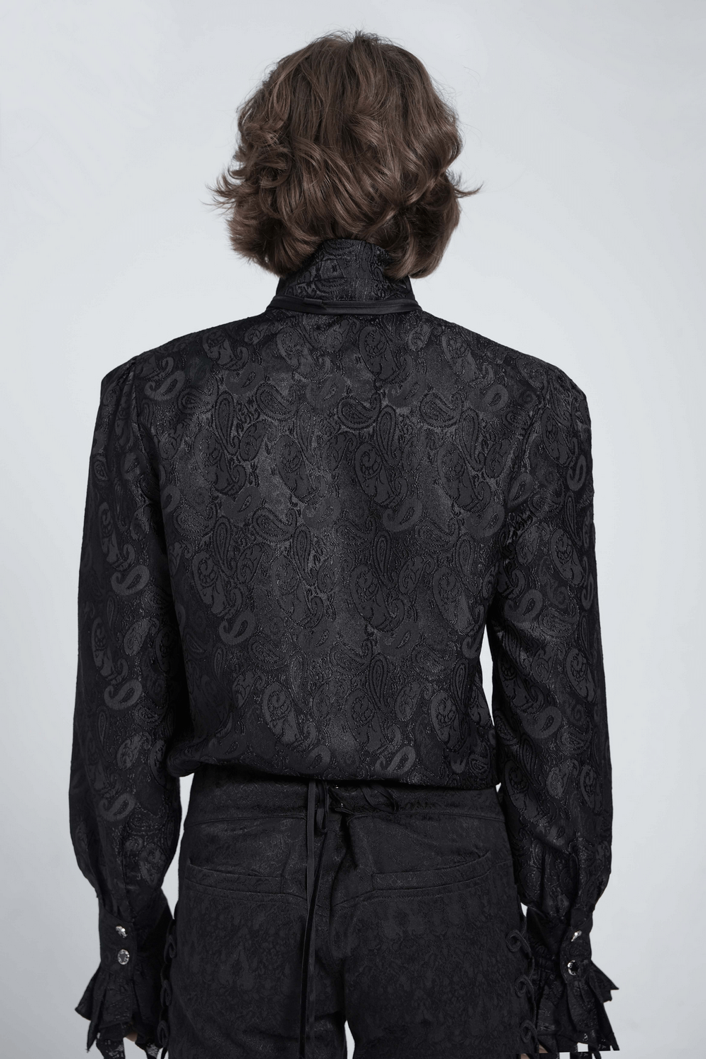 Back view of a stylish black Gothic shirt with intricate patterns and dramatic sleeves.