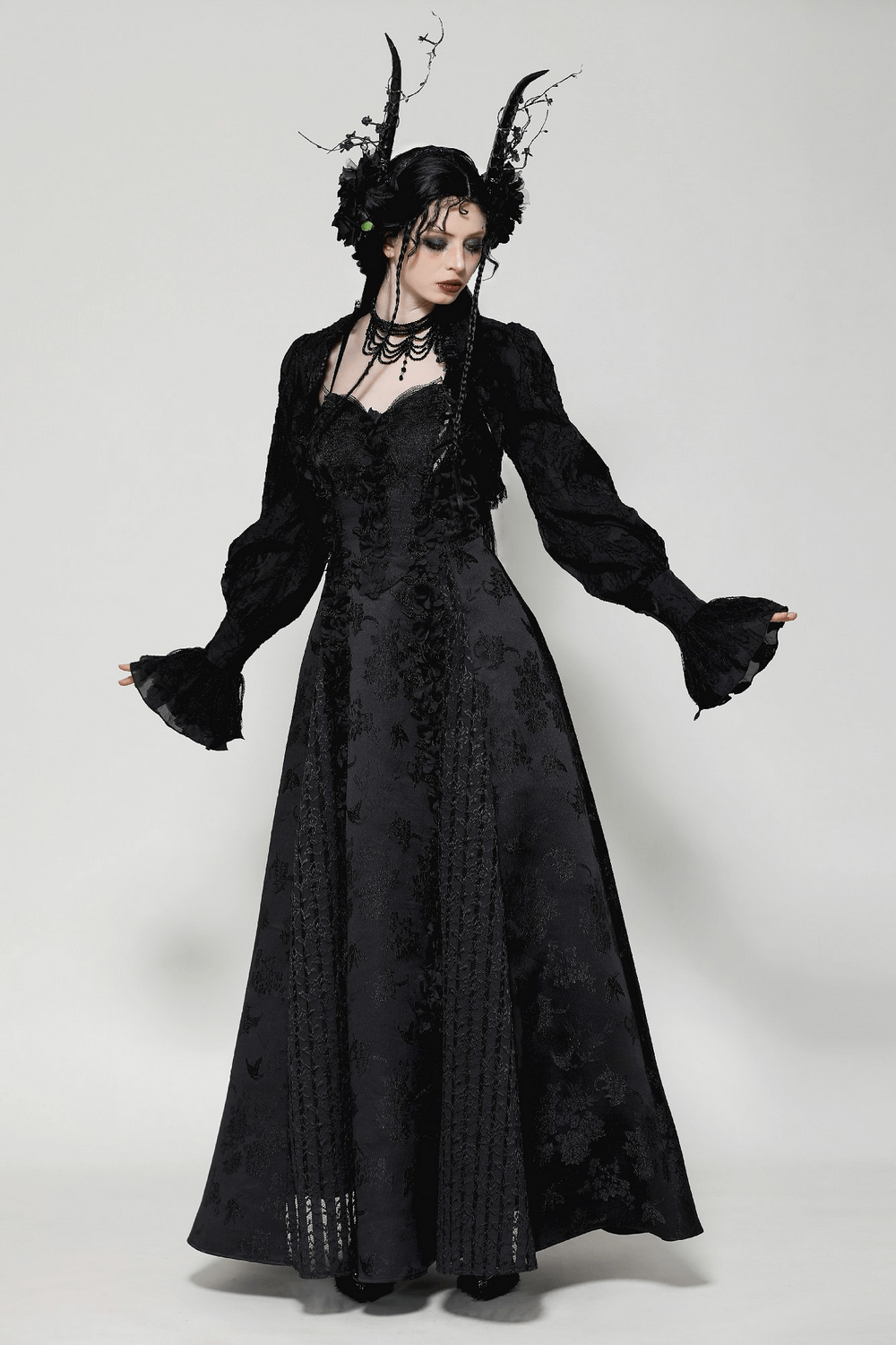 Elegant gothic black dress with ruffled sleeves, lace details, and horned accessories, perfect for a Victorian-inspired look.