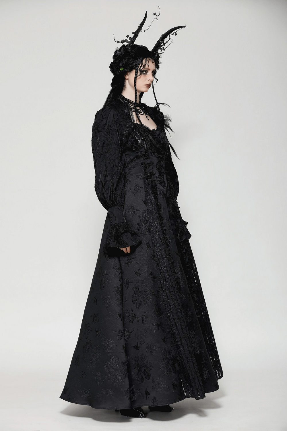 Victorian black dress with intricate lace, ruffles, and striking horns for a gothic-inspired look.