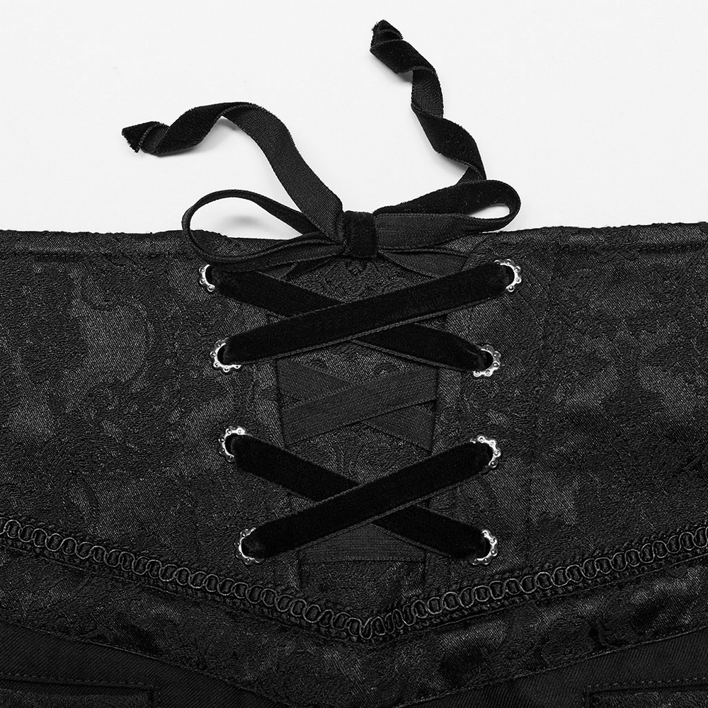 Close-up of elegant black lace corset with a crisscross ribbon design, showcasing gothic style and intricate details.