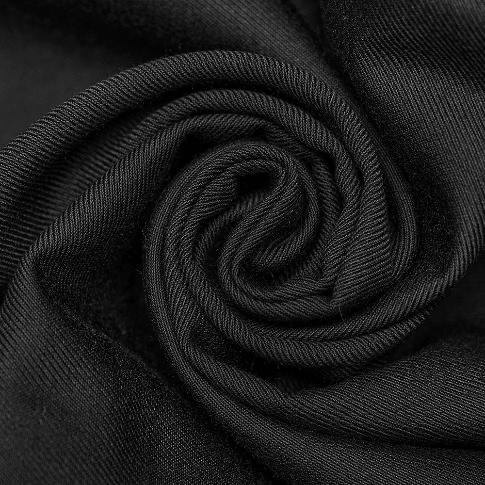 Close-up of luxurious black jacquard fabric showcasing intricate texture for elegant gothic style garments.