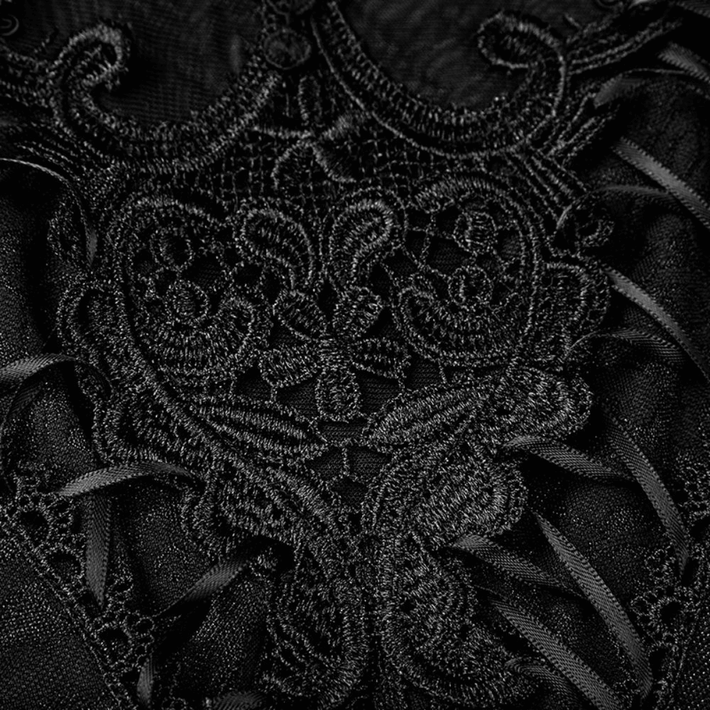 Close-up of intricate black lace detailing on a Gothic-style tank top, showcasing elegant embroidery and fringed accents.