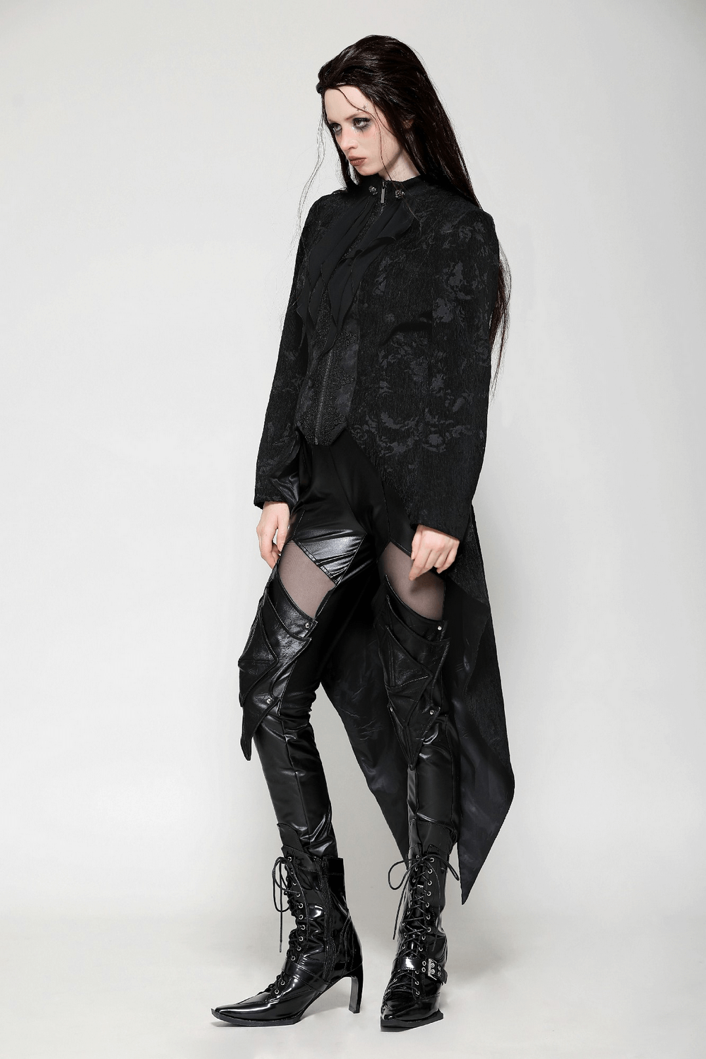 Elegant Gothic tailcoat with ruffled design styled with sleek black leggings and lace-up boots for a modern Victorian look.