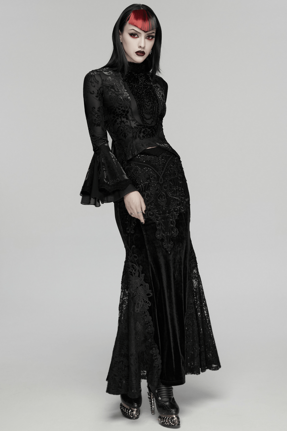 Elegant Gothic Top With Beaded Plunge and Lace Back modeling a stunning dark ensemble with intricate designs.