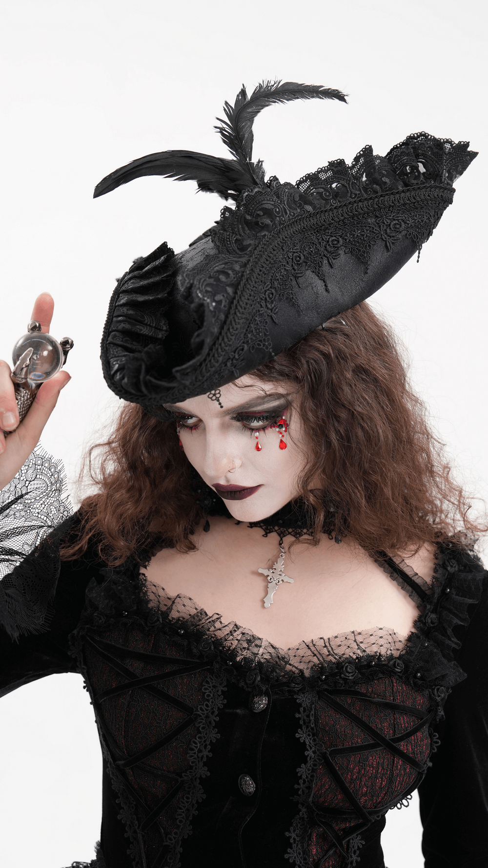 Gothic tricorn hat with lace and feather on model in Victorian cosplay attire.