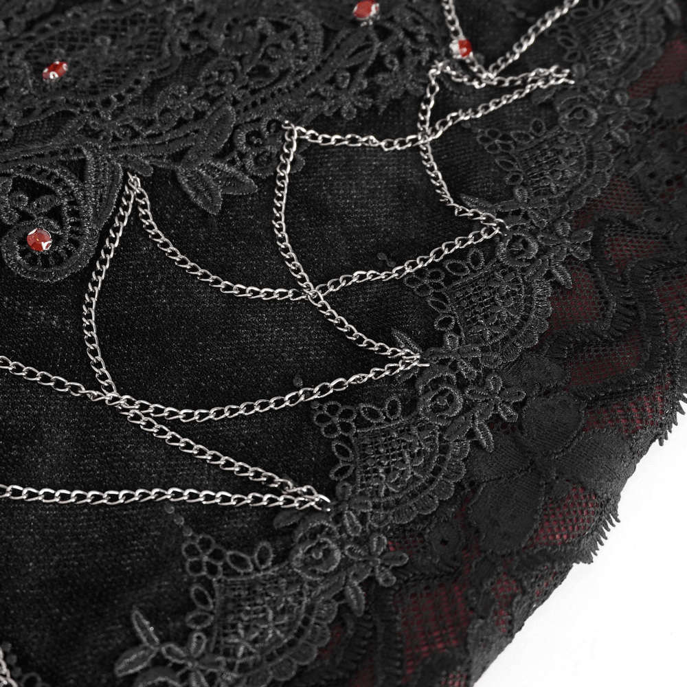 Close-up of elegant black velvet lace skirt featuring intricate designs and shimmering accents for a gothic look.