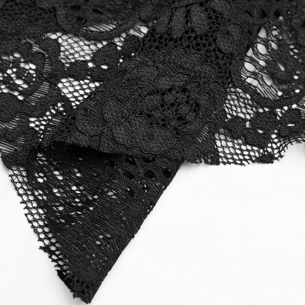 Close-up of intricate black lace fabric with floral patterns, perfect for gothic or Victorian-inspired fashion.