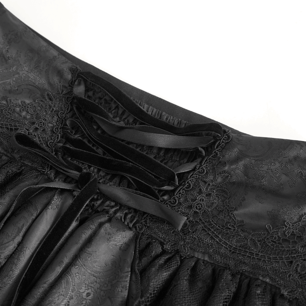 Close-up of the elegant lace waistband of a Gothic Victorian skirt with ruffles, featuring intricate detailing and black ribbons.