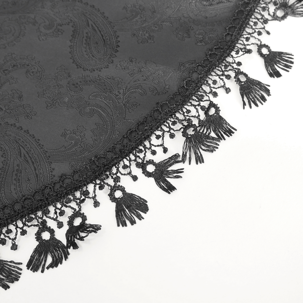 Elegant black lace fabric with intricate paisley pattern and delicate fringed trim, perfect for Gothic clothing.