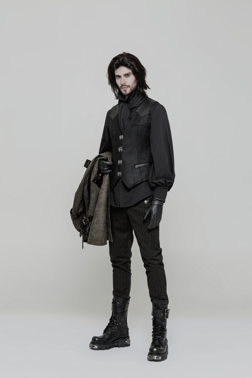 Elegant Gothic Victorian waistcoat with buckles, styled with black pants and gloves for a steampunk look.