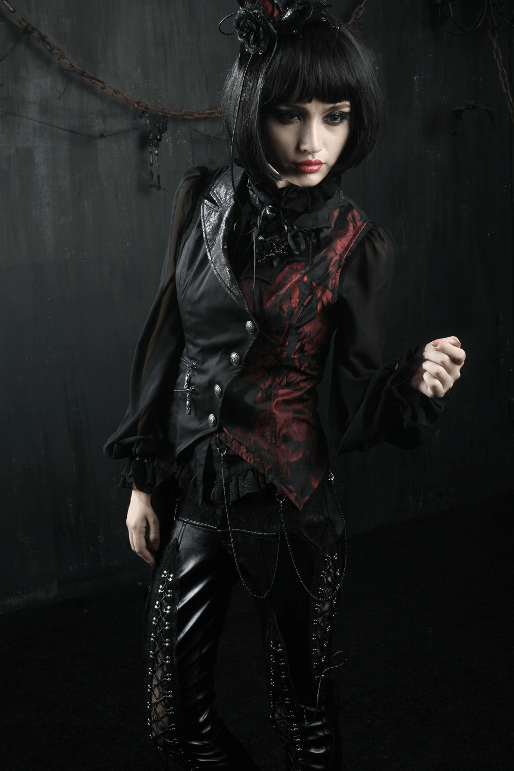 Elegant Gothic women's asymmetrical black-red waistcoat, stylishly paired with lace and leather pants.