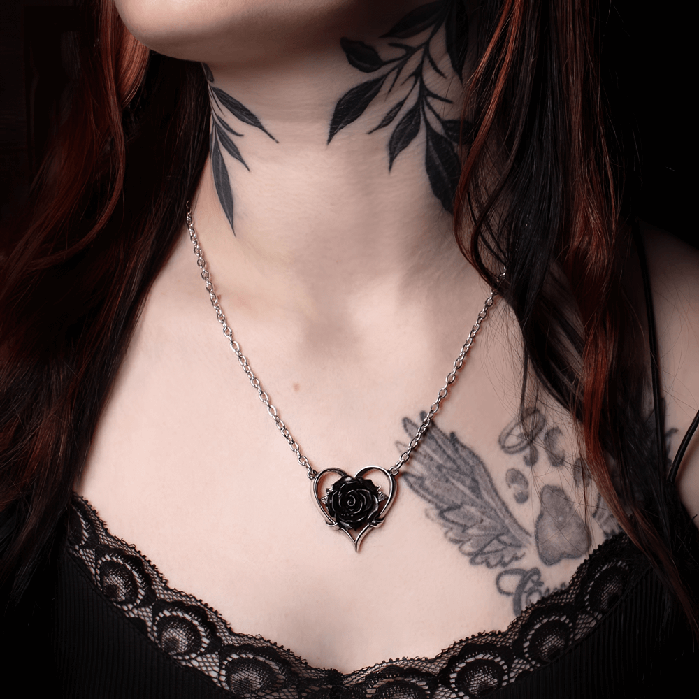 Elegant Heart of Blackness Pendant featuring a black rose, displayed on model with tattoos and dark lace top.