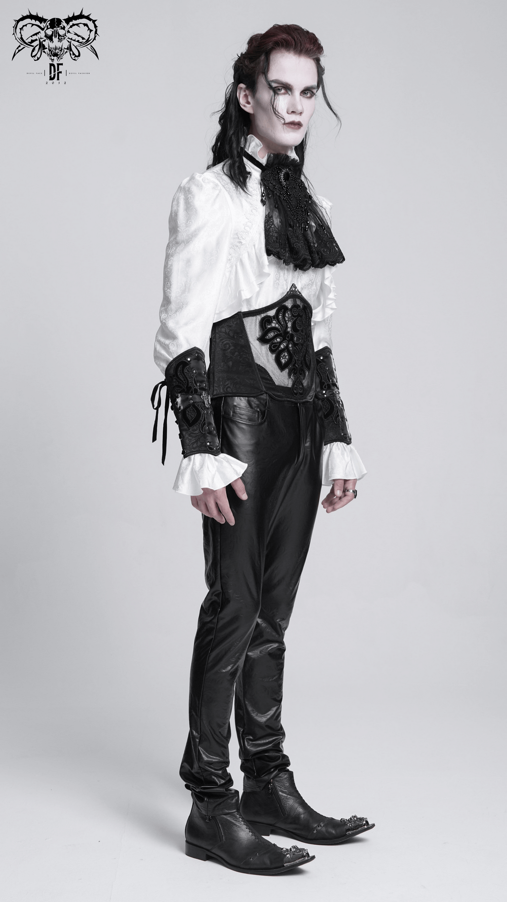 Elegant gothic model wearing a lace and mesh corset belt, paired with black pants and a dramatic white shirt.