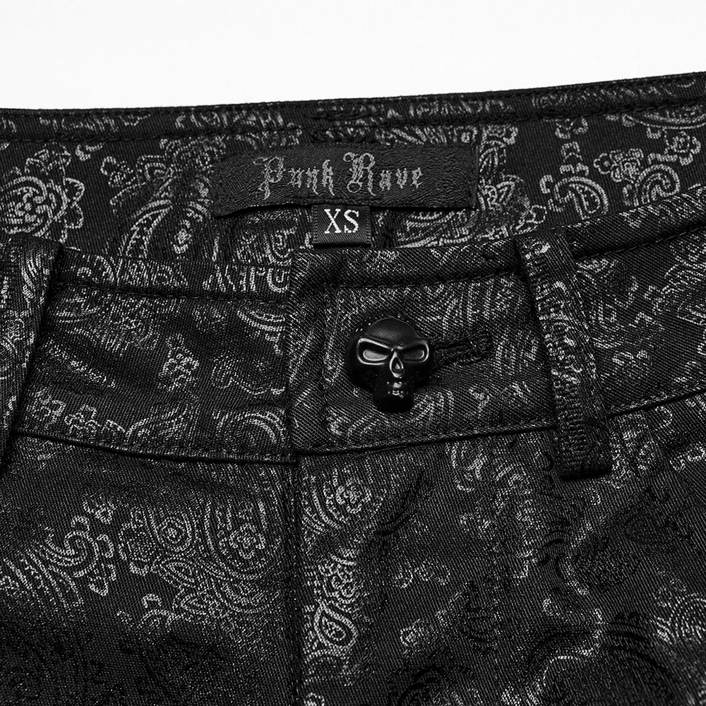 Close-up of black leggings with intricate pattern, featuring Punk Rave label and decorative skull button.