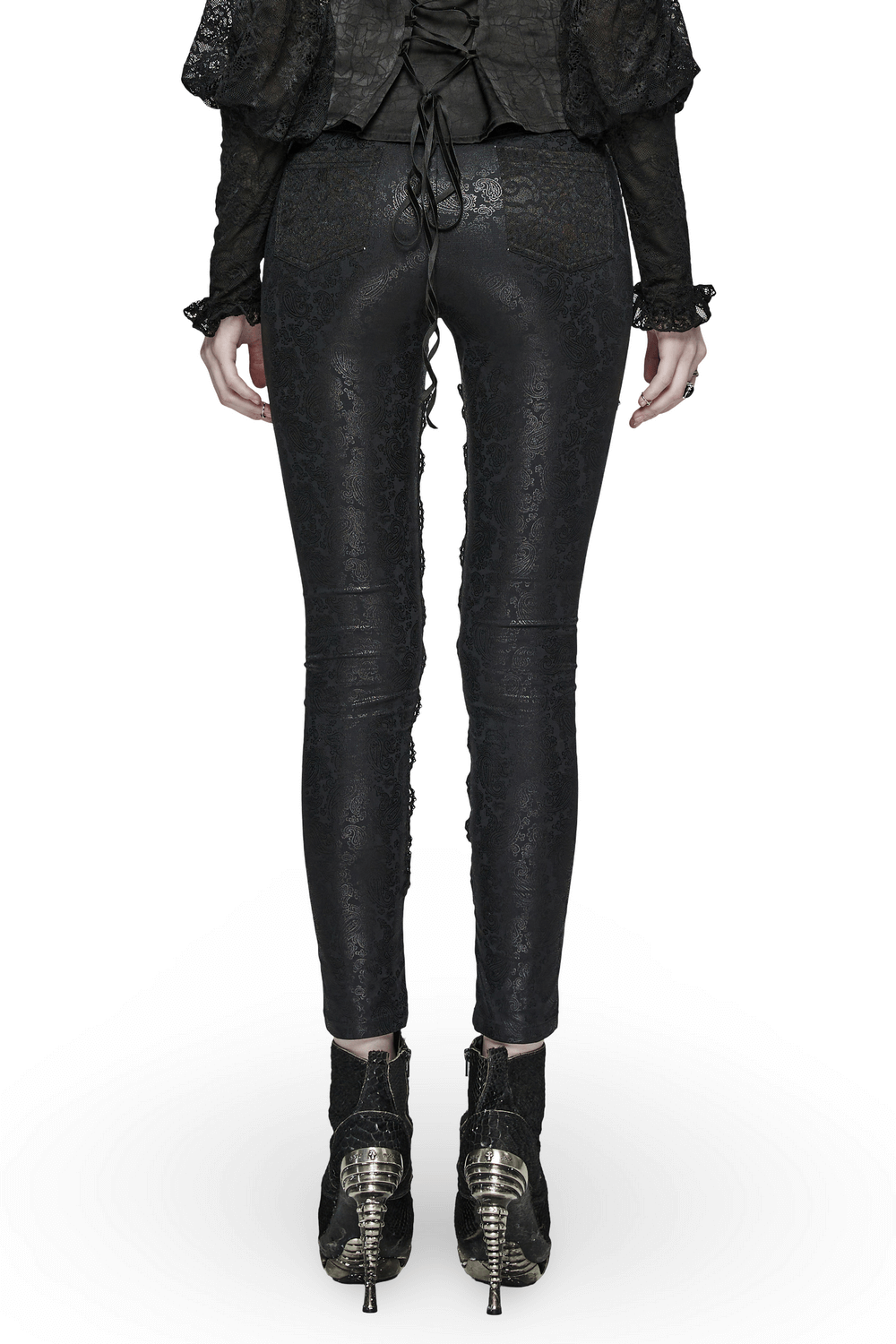 Elegant black leggings with intricate lace patterns and lace-up details, paired with stylish high-heeled shoes.