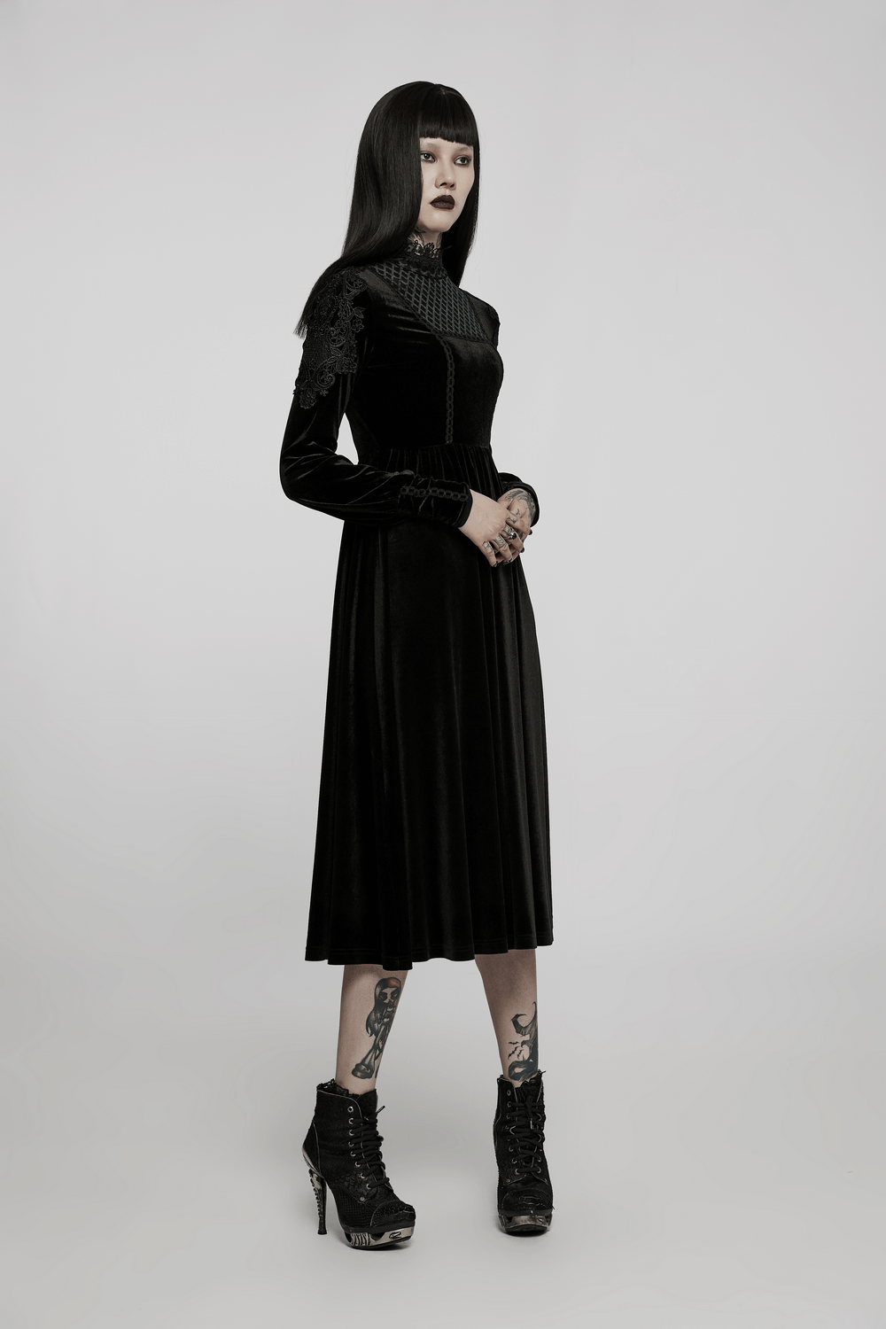 Elegant black velvet gothic dress with lace collar and appliqued sleeves, perfect for sophisticated occasions.