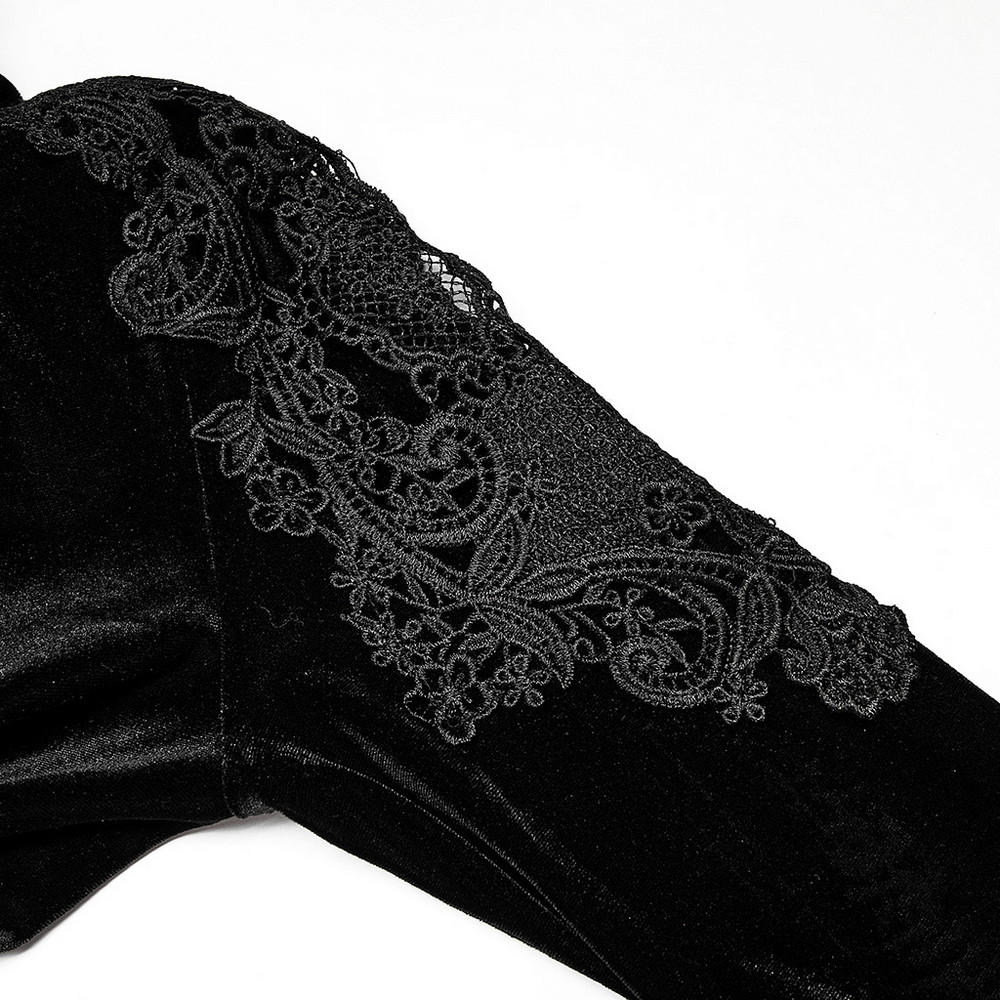 Close-up of intricate lace appliqué on the sleeve of an elegant gothic velvet dress.