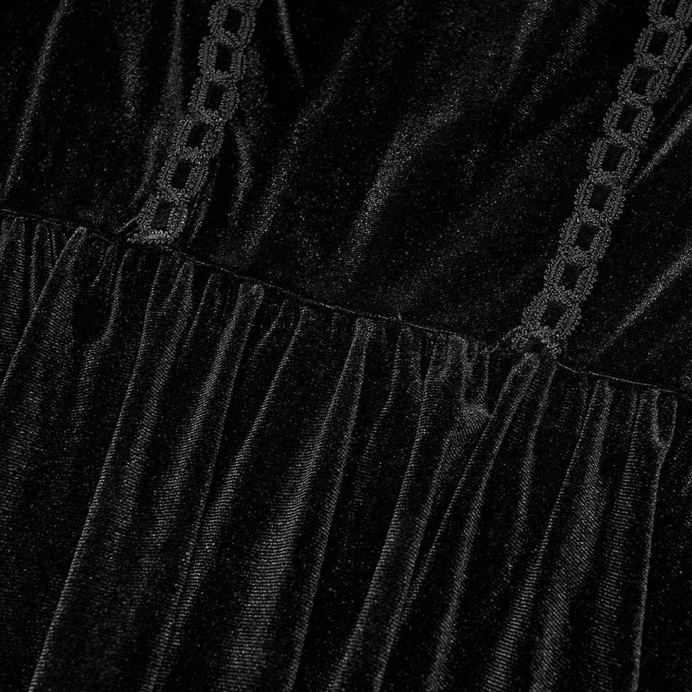 Close-up of luxurious black velvet fabric with lace detailing, showcasing sophisticated Gothic style.