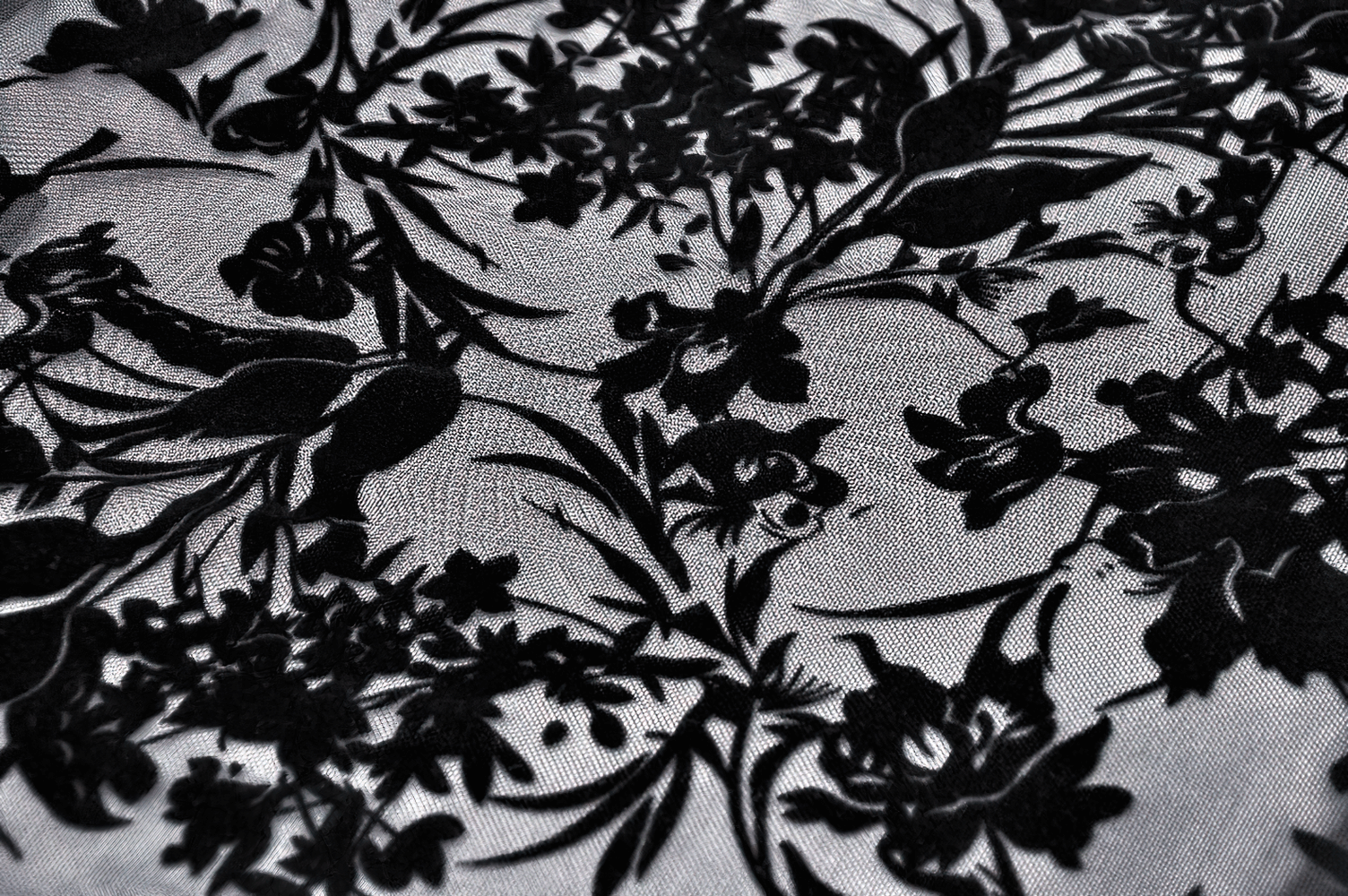 Elegant black floral lace pattern on sheer mesh fabric, perfect for a gothic Victorian Bardot top.