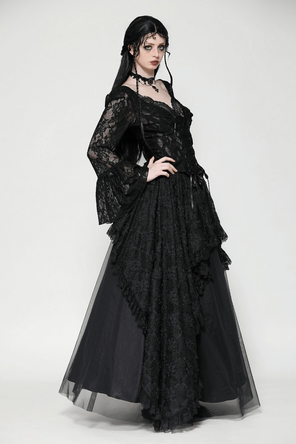 Elegant gothic woman in a black lace layered maxi skirt, showcasing a dramatic silhouette and intricate detailing.