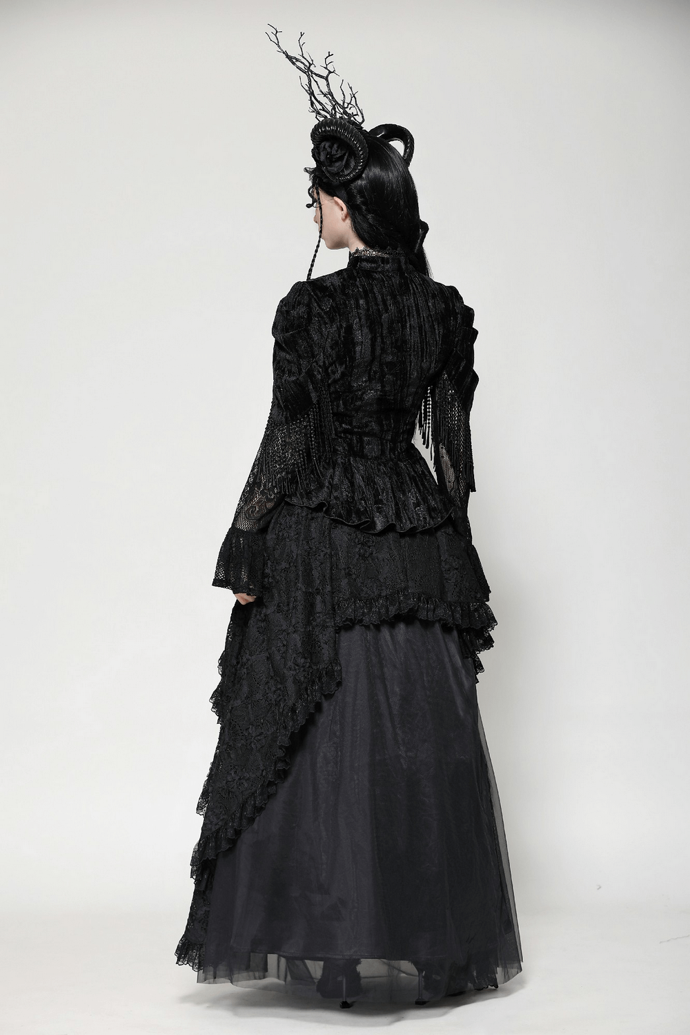 Elegant black gothic outfit showcasing a textured lace jacket and layered maxi skirt from the back.