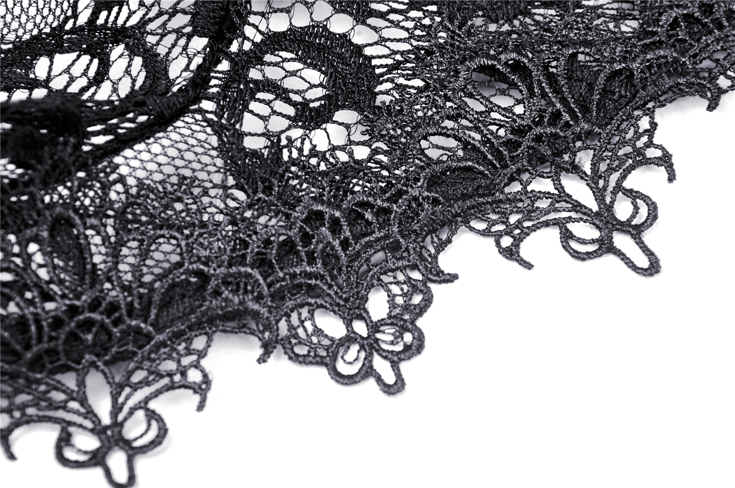 Close-up of intricate black lace design with floral patterns, ideal for gothic fashion and elegant layering.