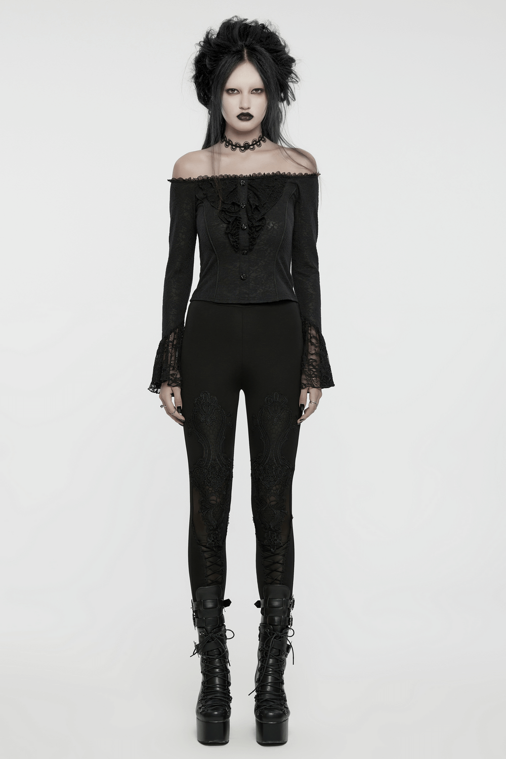 Elegant lace off-shoulder ruffle top with long sleeves, paired with fitted pants and stylish platform boots.