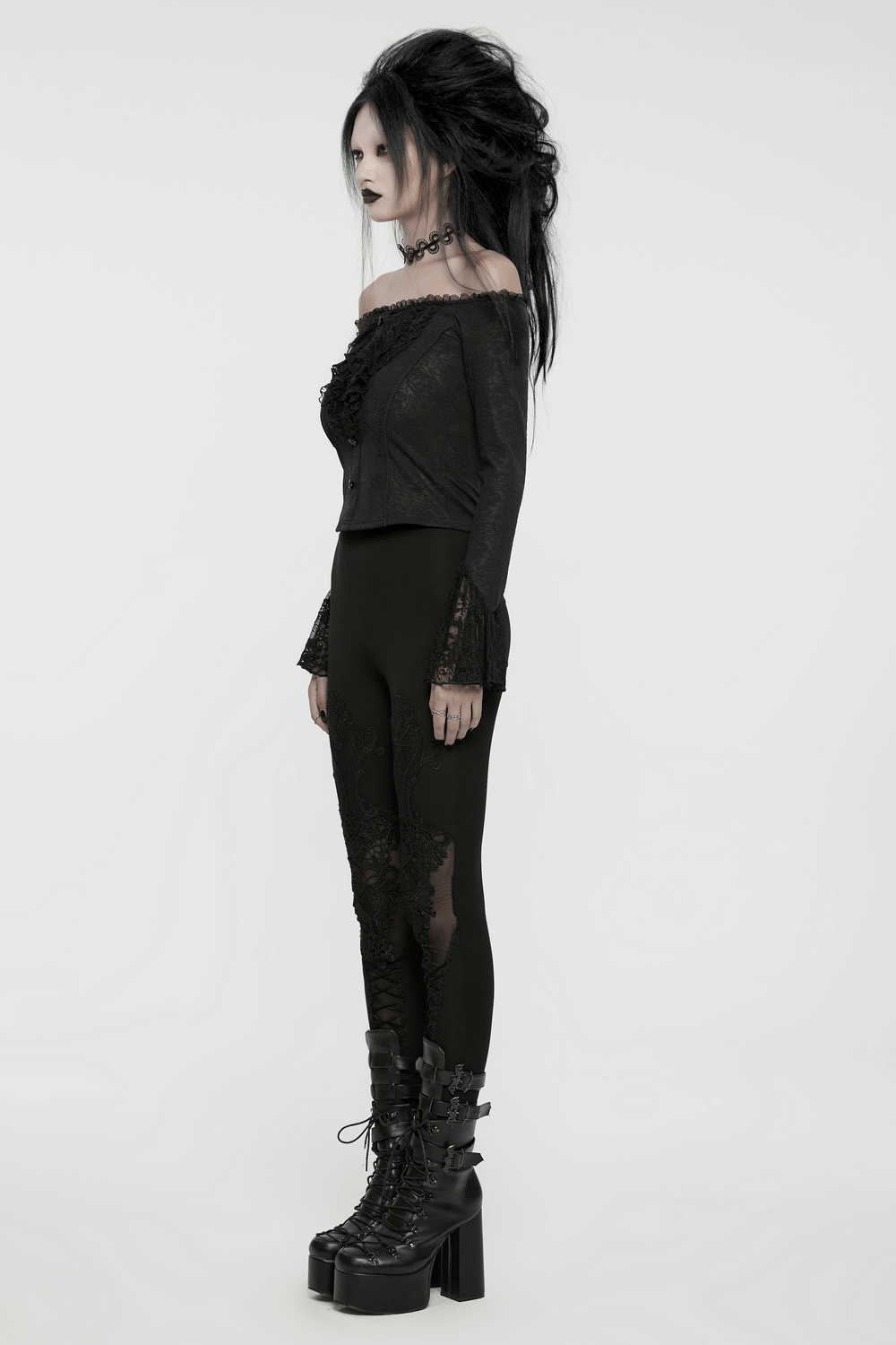 Elegant lace off-shoulder ruffle top with long sleeves, paired with gothic-inspired leggings and chunky boots.