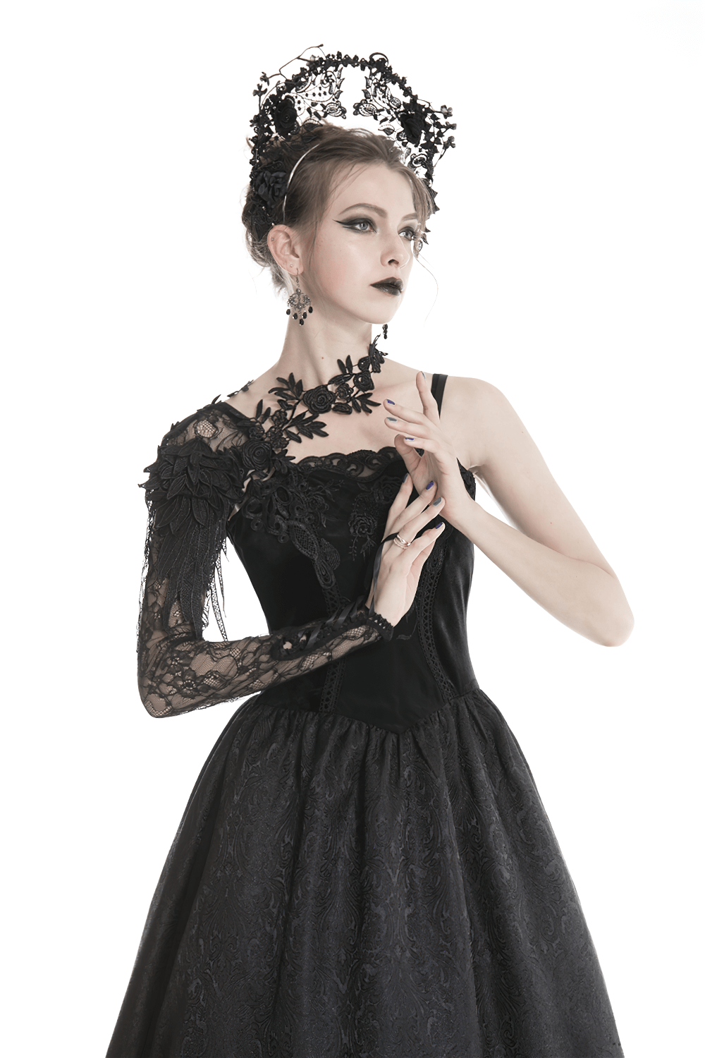 Elegant gothic lace sleeve accessory with floral appliques, worn by model in black dress and accessories.