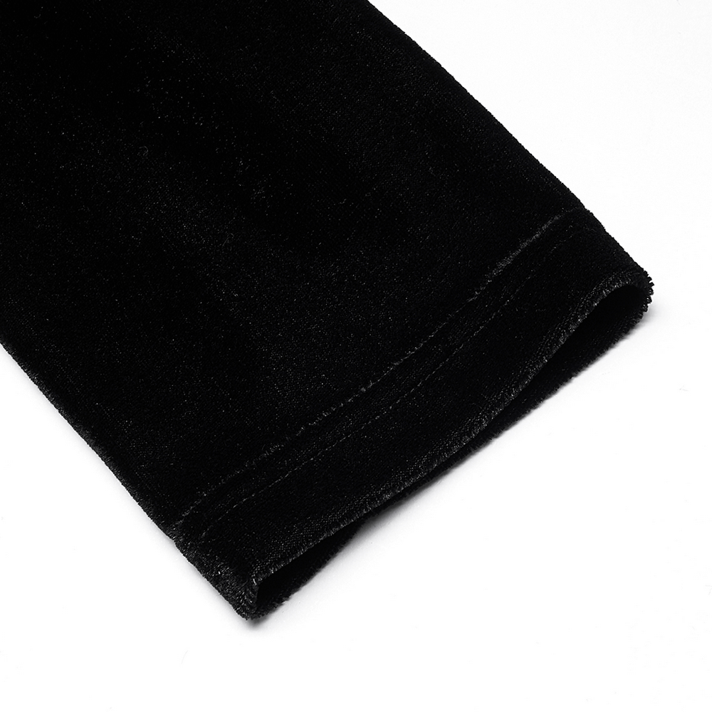 Close-up of soft black velvet fabric showcasing the elegant sleeve detail of a gothic-inspired midi dress.