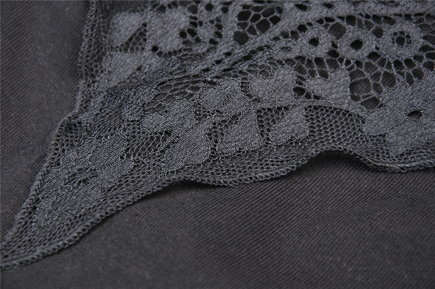 Close-up of elegant black lace trim on a bodycon dress, showcasing intricate details and textures.