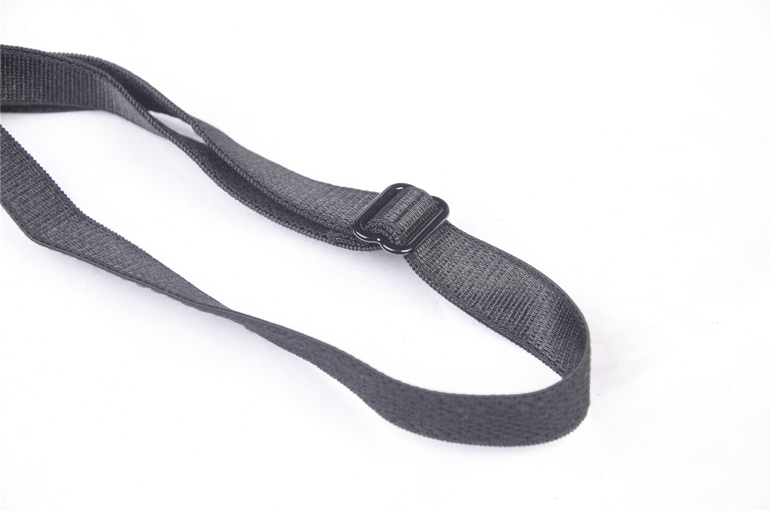 Close-up of a sleek black strap with adjustable buckle, perfect for accessories or clothing.
