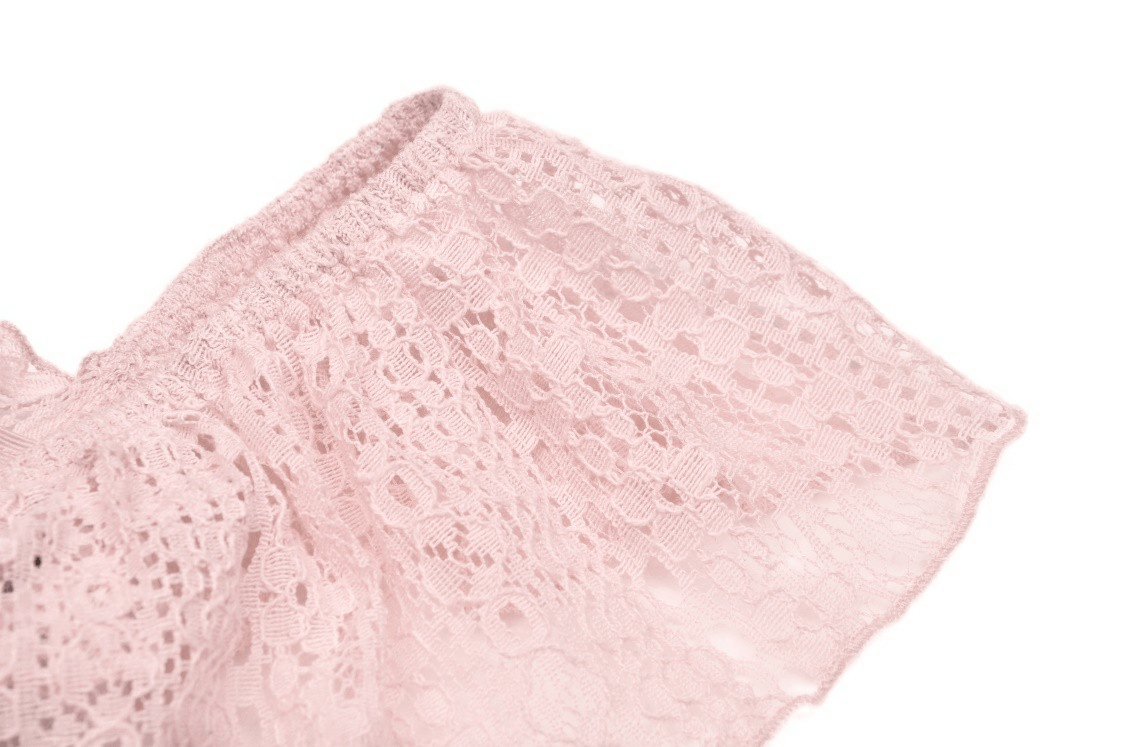 Close-up of soft pink lace detail, showcasing intricate patterns and textures for a stylish touch.
