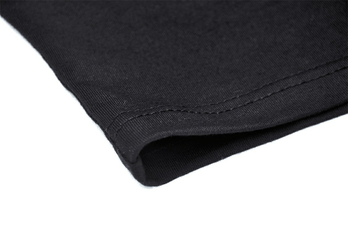 Close-up of black fabric hem showcasing high-quality stitching for an elegant crop top.