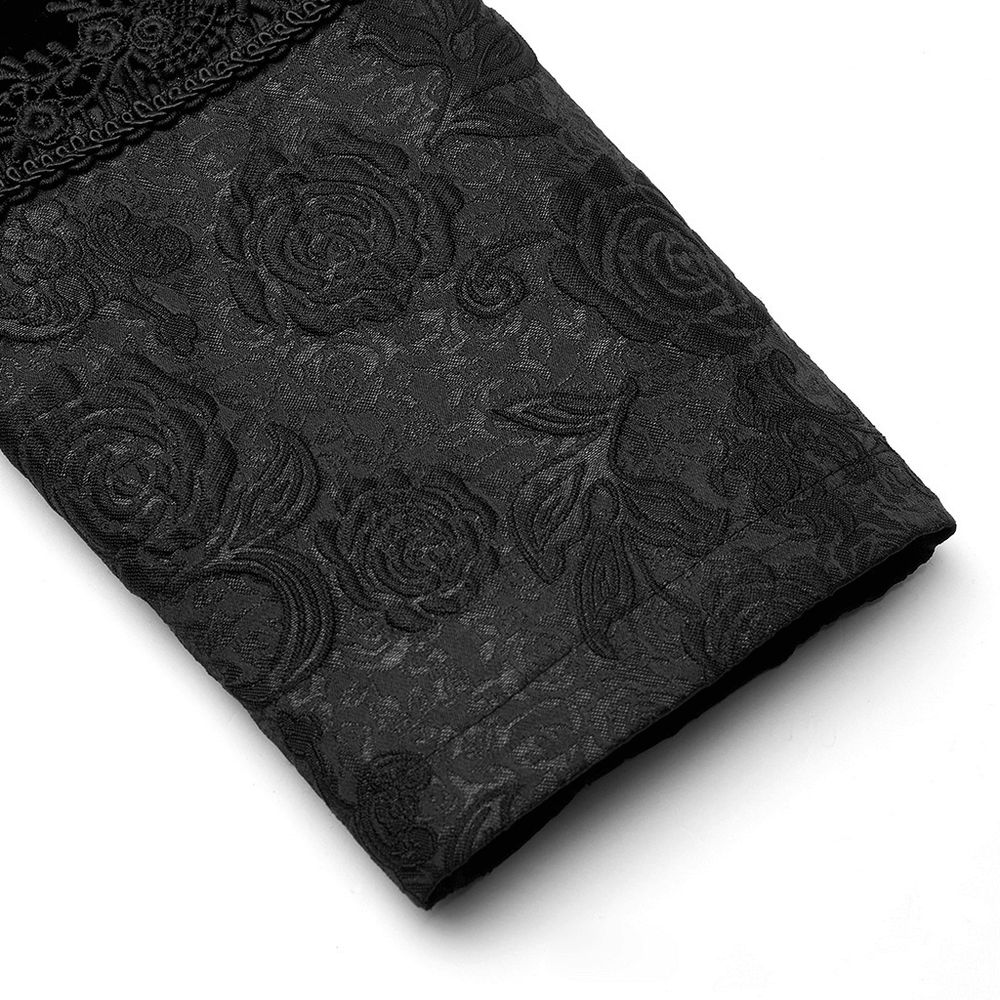 close-up of elegant black lace-trimmed fabric with intricate rose jacquard design on a Gothic coat sleeve.