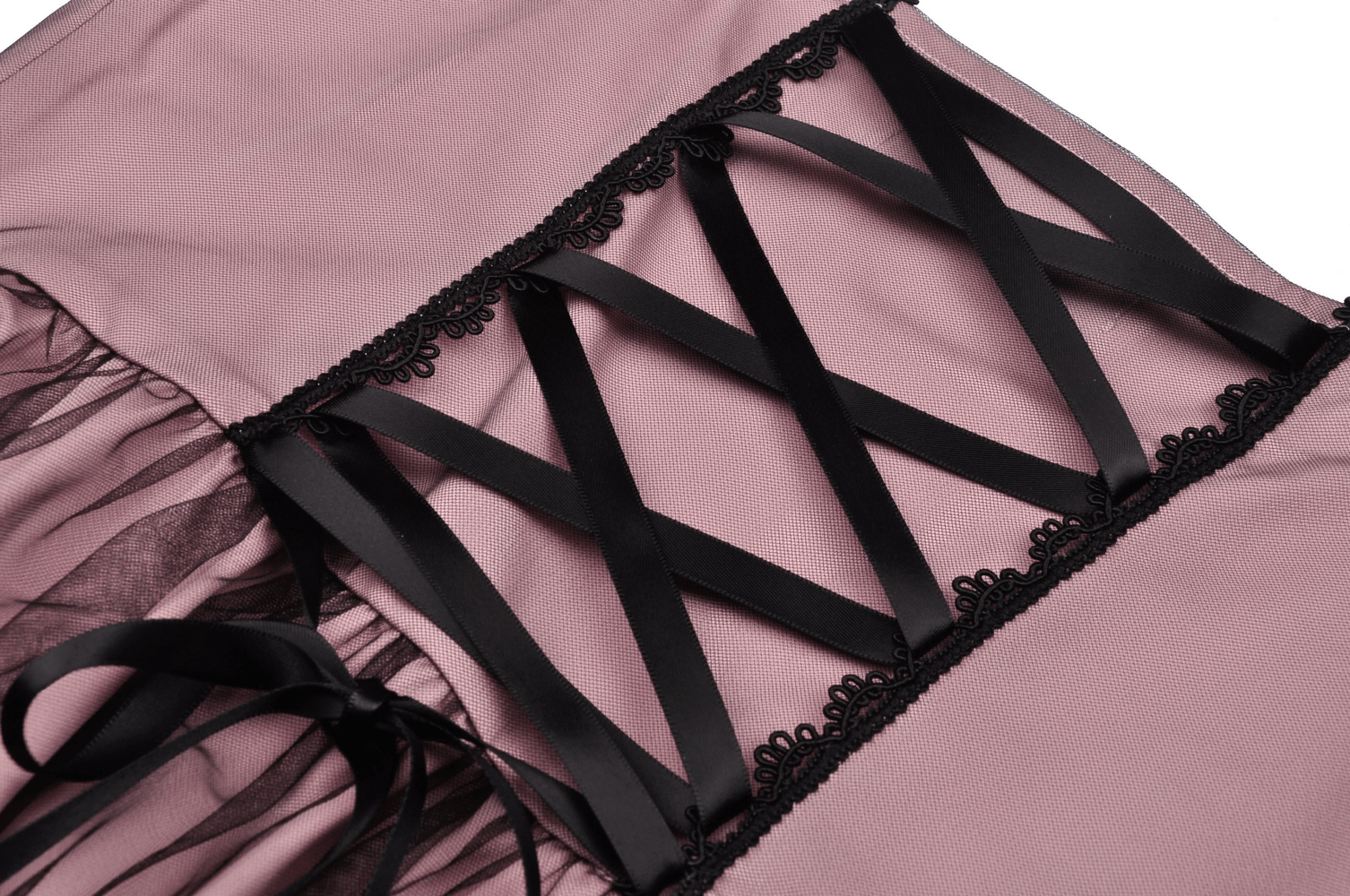 Close-up of elegant lace-up dress with black lace accents and ruffled hem showcasing delicate details.