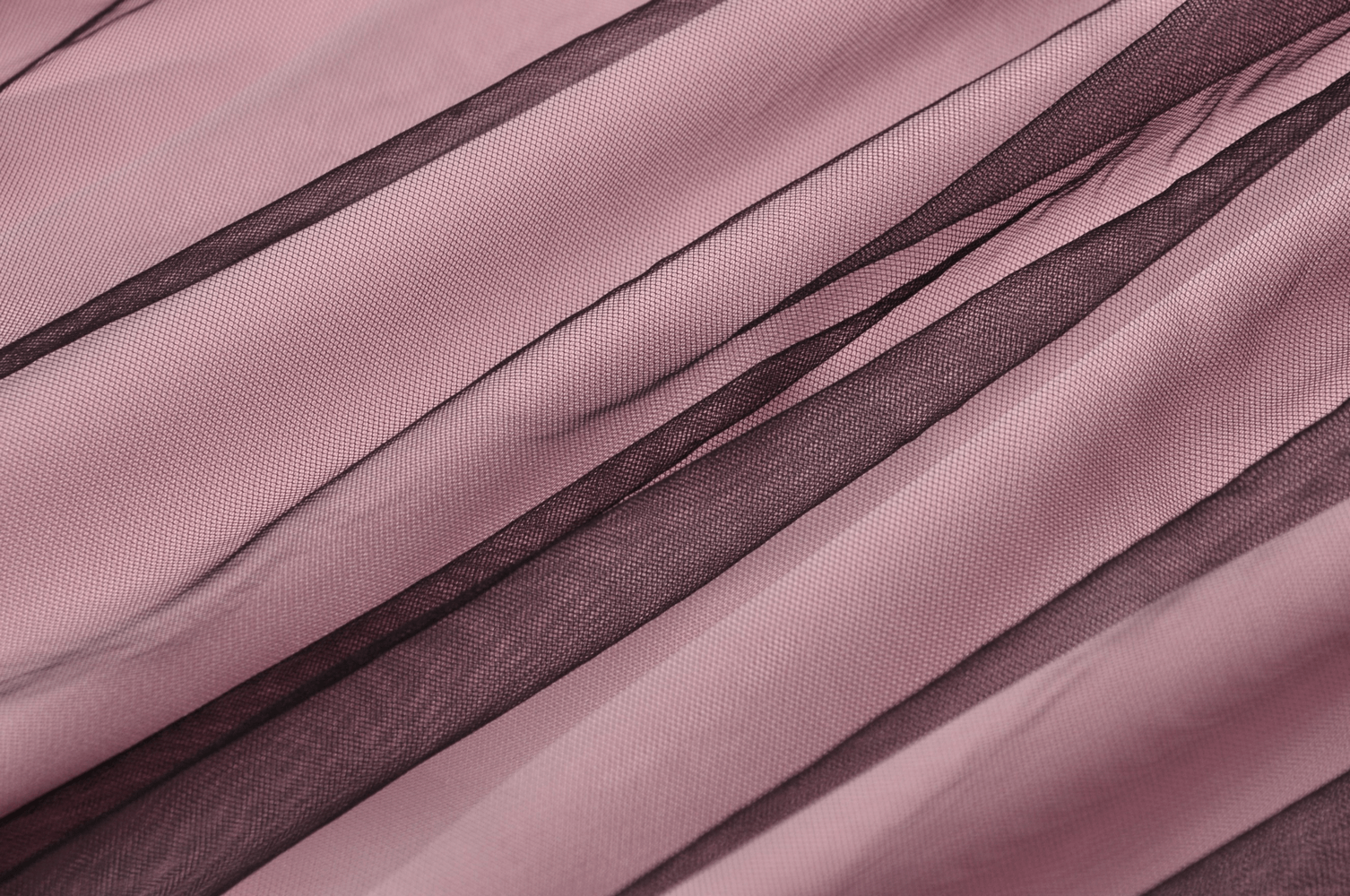 Elegant fabric with layers of soft pink and contrasting black lace, showcasing textures for a stylish gothic mini dress.