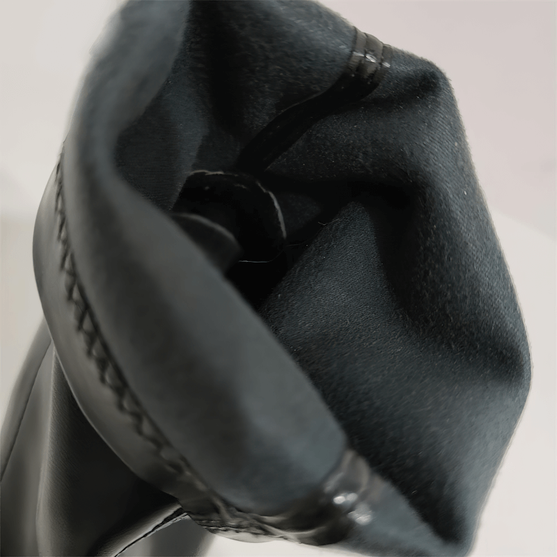 Close-up view of the interior of elegant women's leather boots featuring soft lining and stylish stitching details.