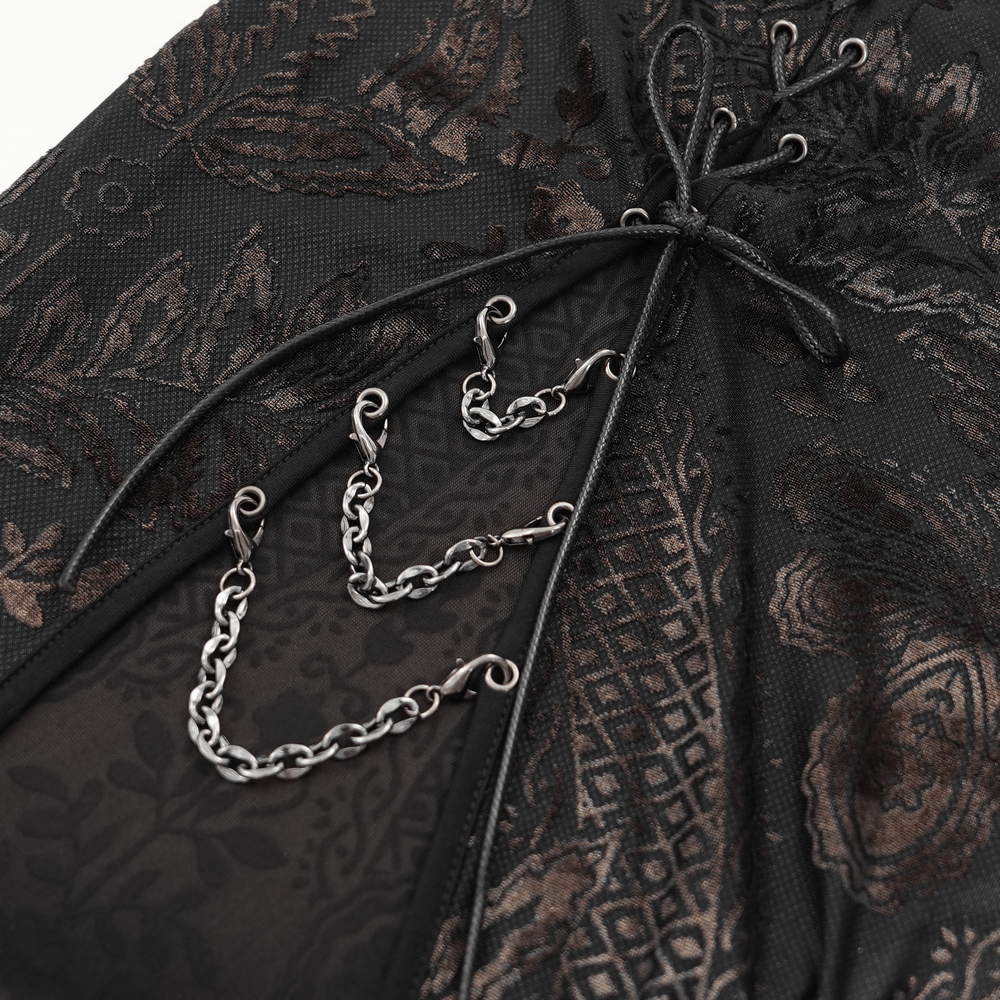 Close-up of elegant gothic lace dress featuring intricate floral patterns and stylish chain details.