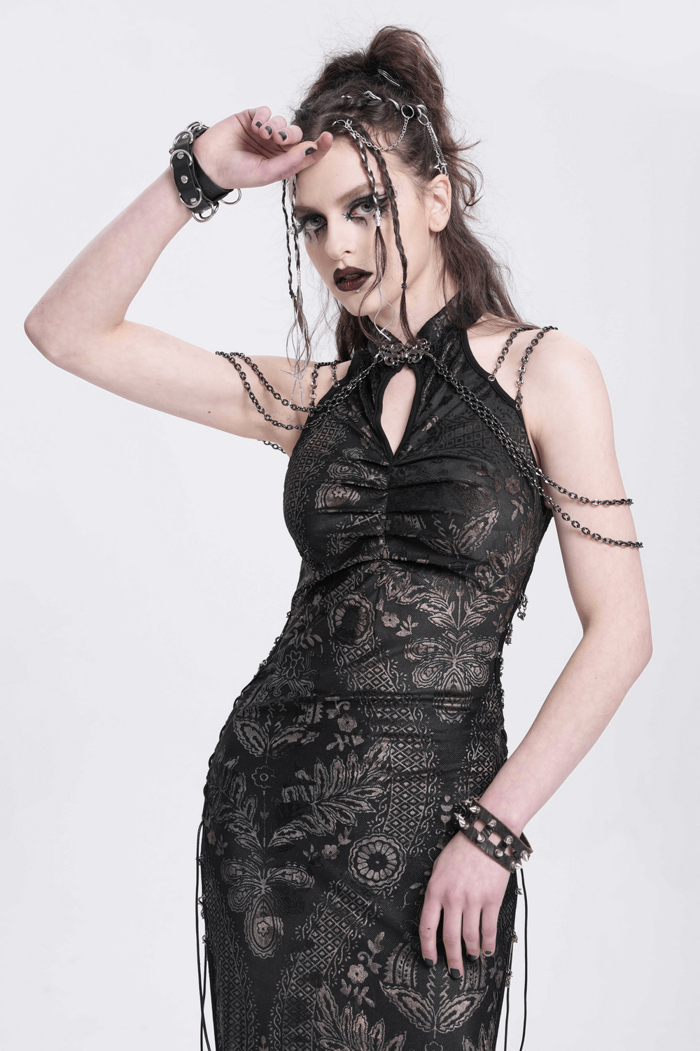 Elegant gothic lace dress with chain detail and floral embroidery, showcasing a unique silhouette and side slits.